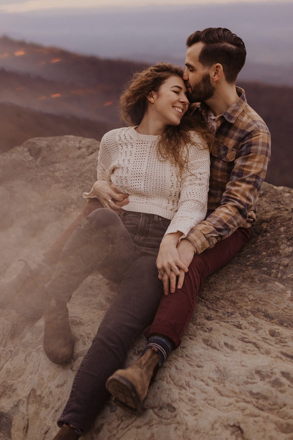 couple embraces on Shenandoah overlook for fall engagement photos