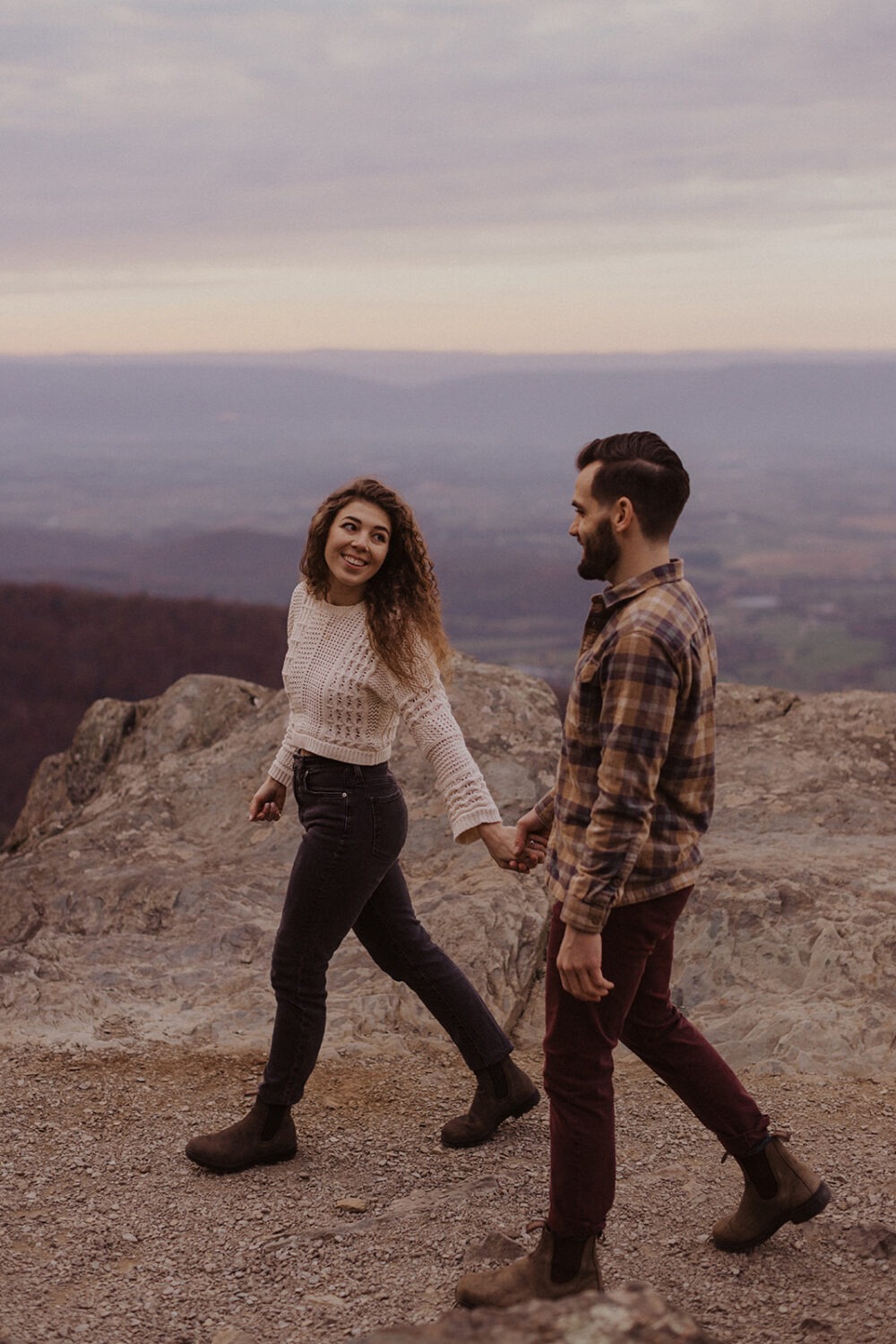 couple walks holding hands at Shenandoah fall engagement photos