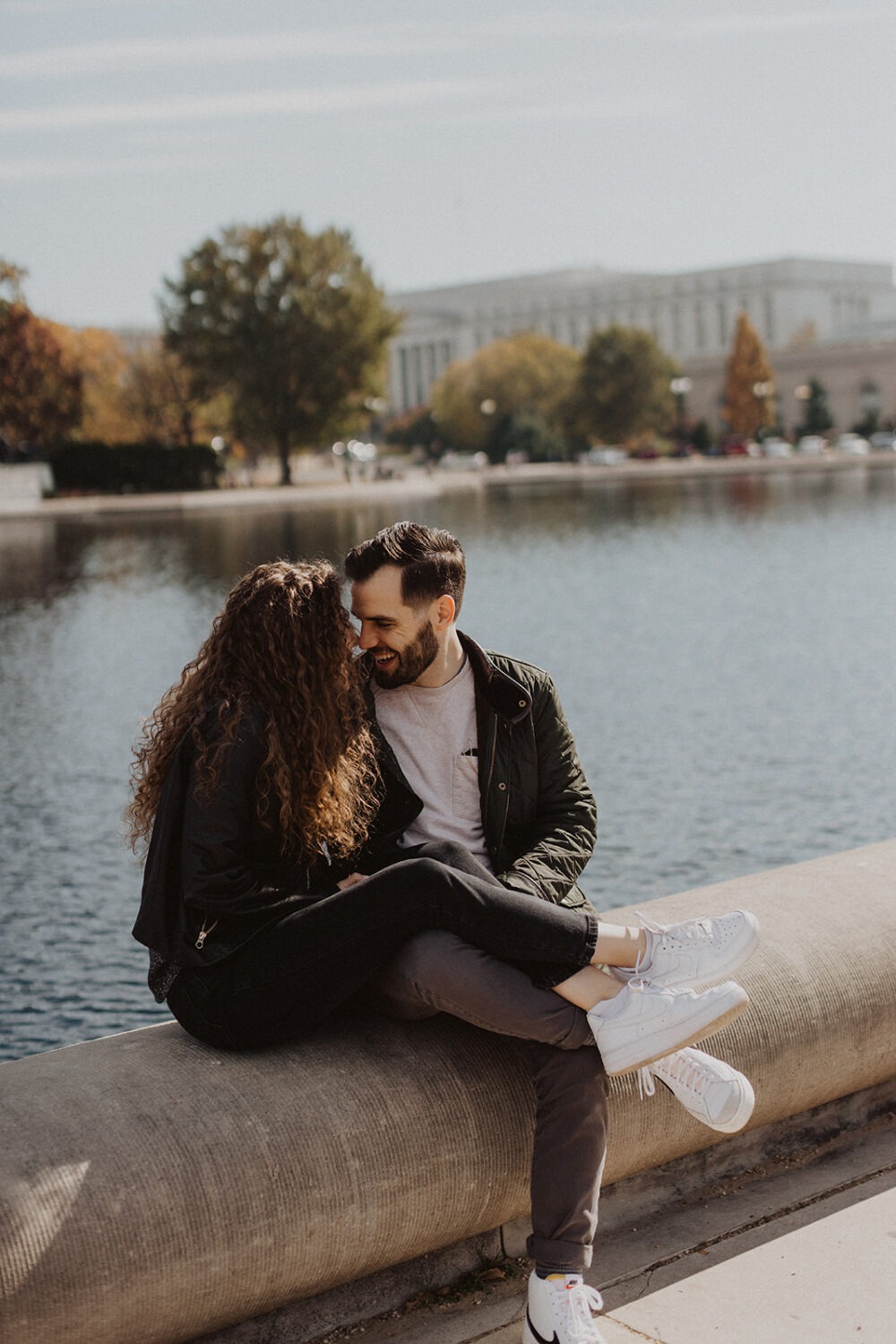 couple sits together at DC National Mall engagement session