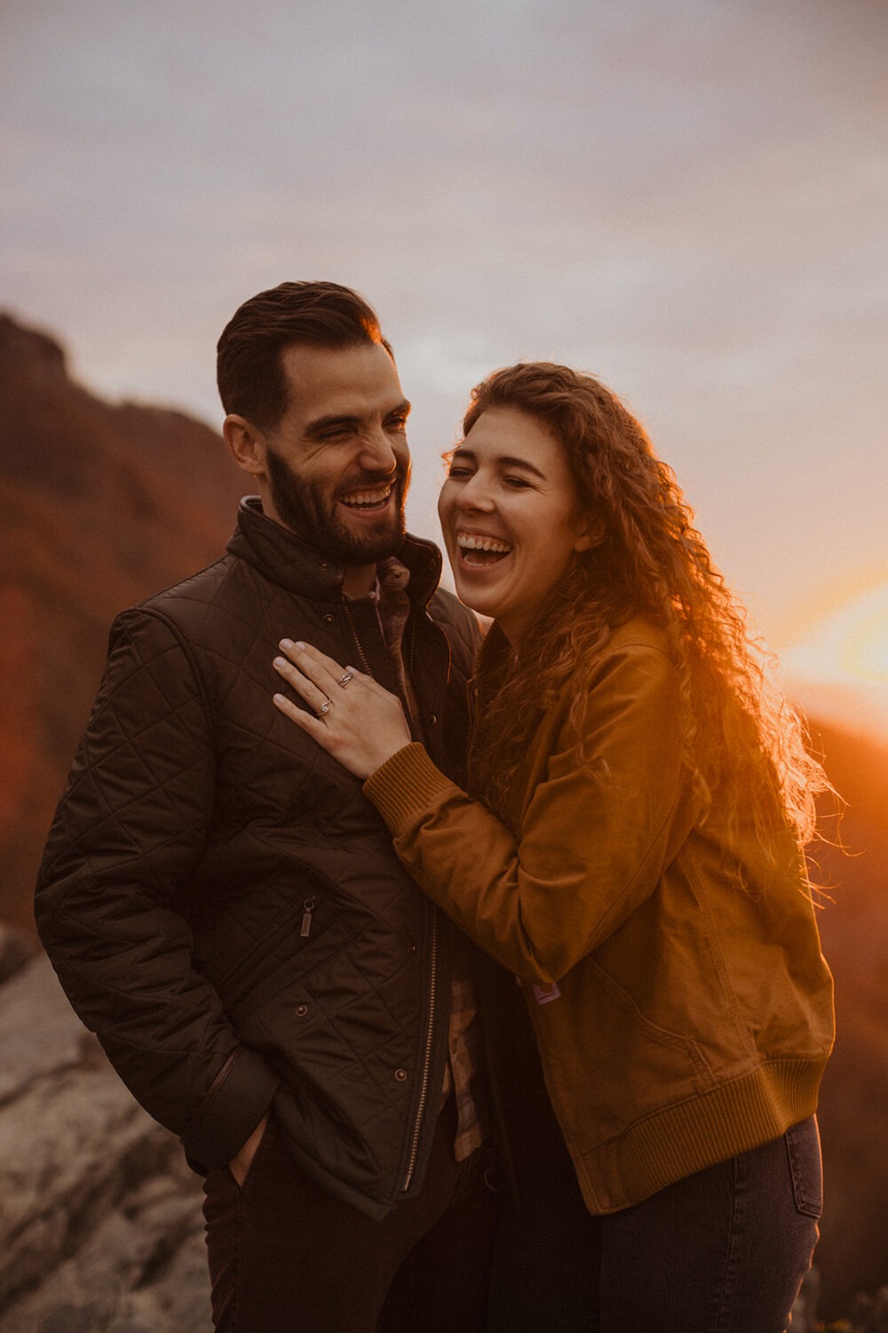 couple embraces at sunset engagement session