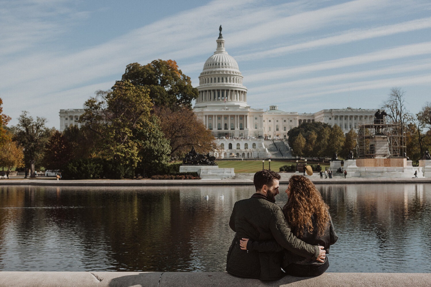 couple sits together at DC National Mall engagement session