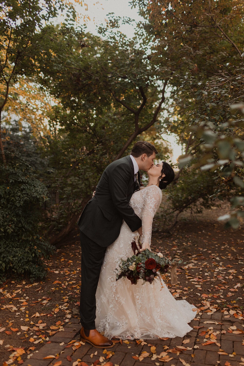 couple kisses at fall DC wedding