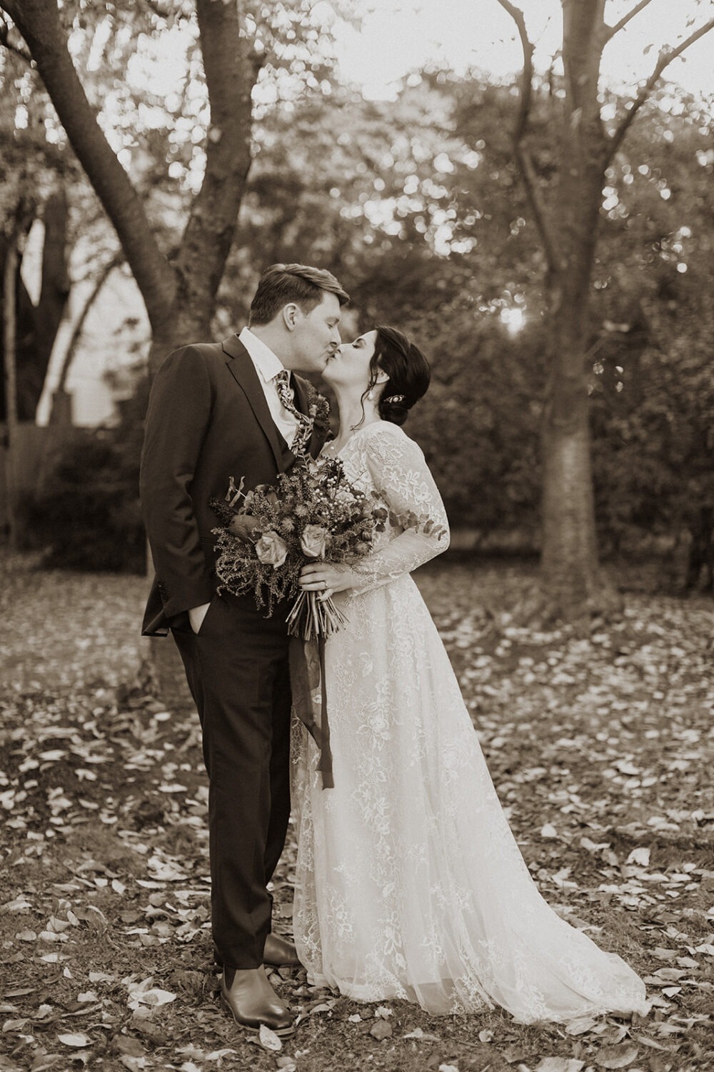 couple kisses at fall DC wedding