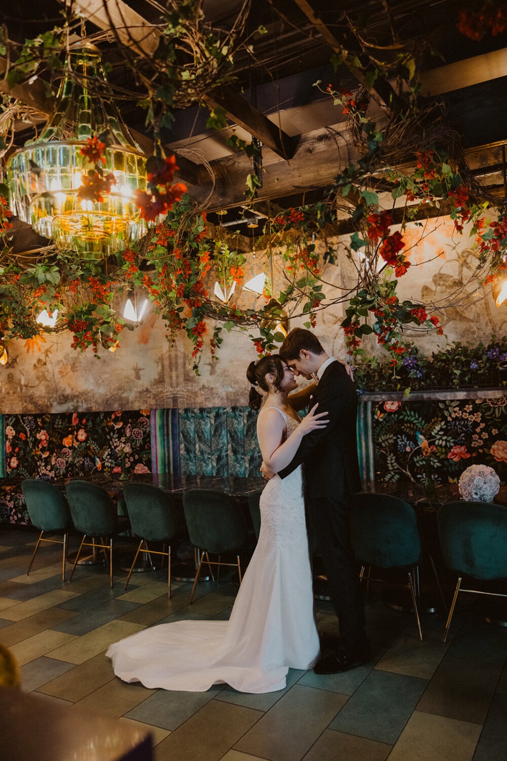 couple embraces in floral-themed room at La Vie Restaurant