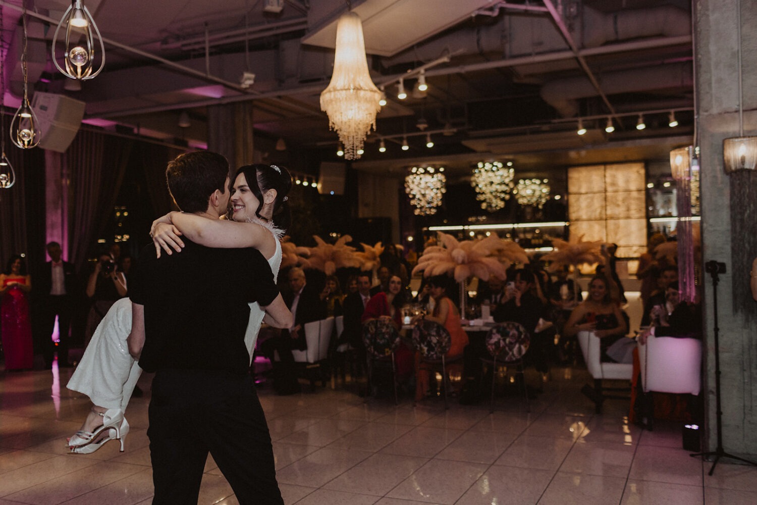 couple dances at La Vie Restaurant venue with seated guests in the background