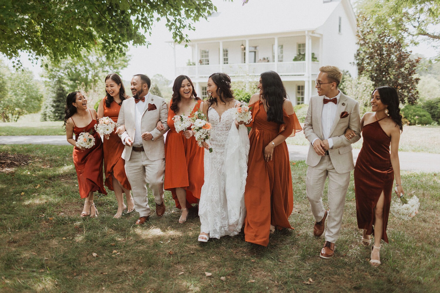 bride walks laughing with bridesmaids