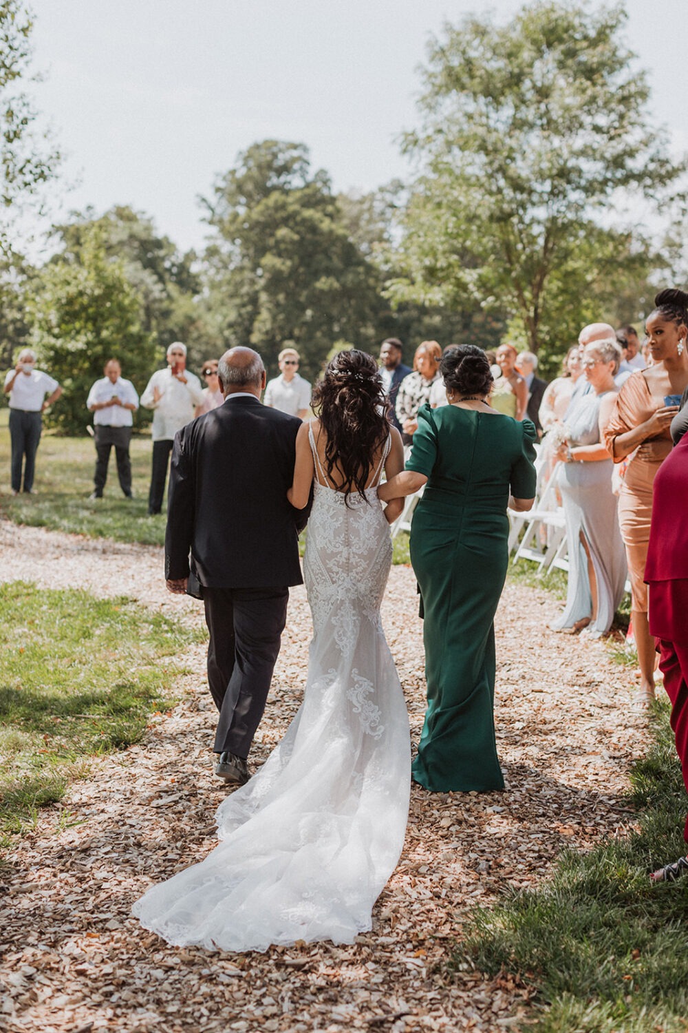 bride walks down aisle with parents