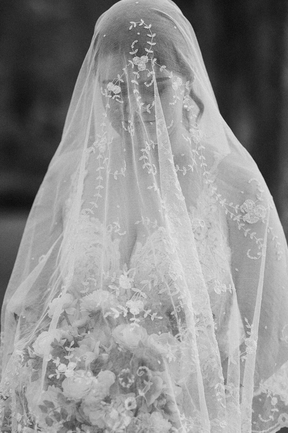 bride wears white lace veil 