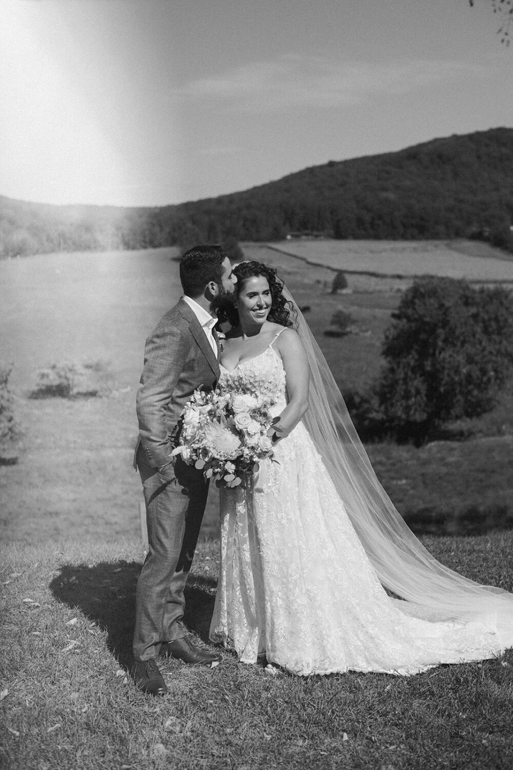 couple embraces in meadow 