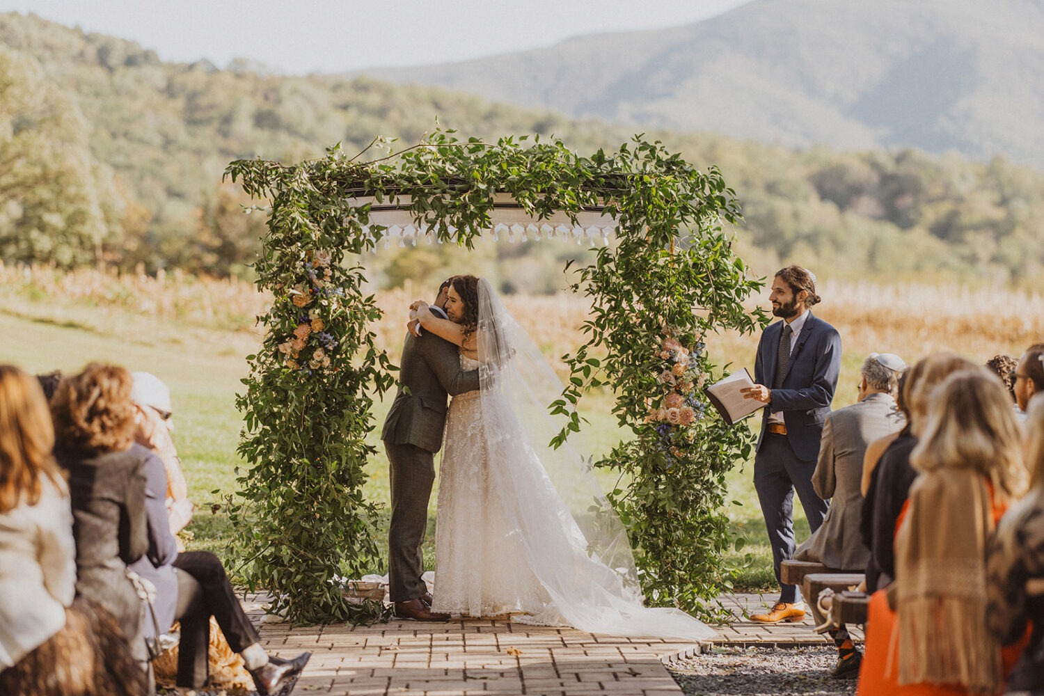 couple embraces at outdoor wedding ceremony