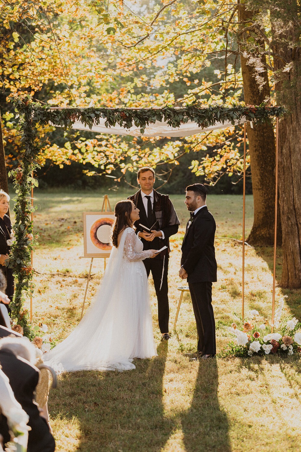 couple exchanges vows at outdoor wedding ceremony