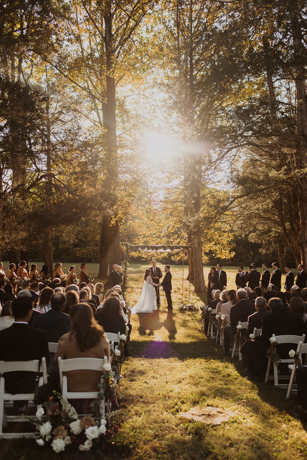 couple exchanges vows at outdoor wedding ceremony