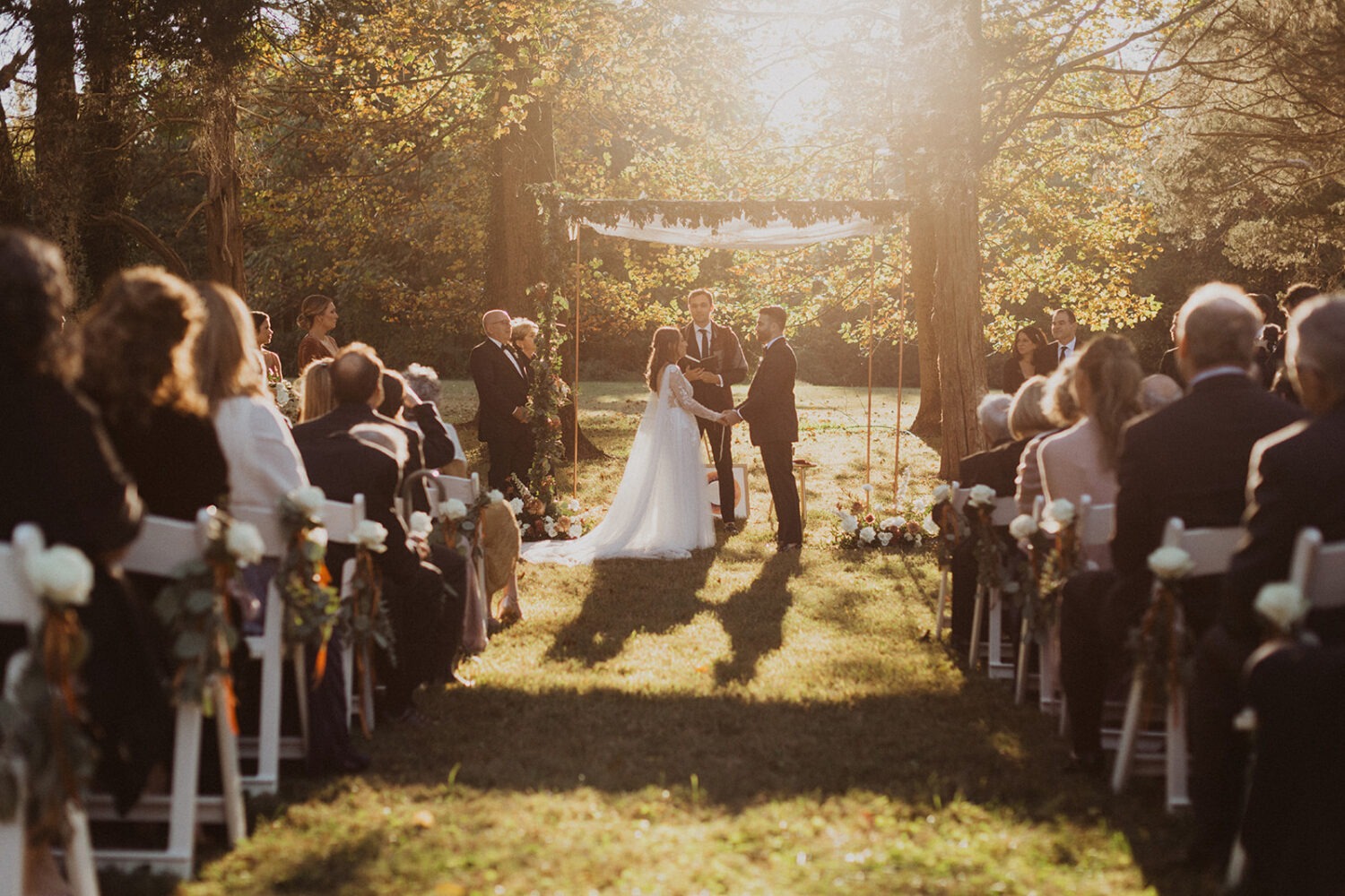 couple exchanges vows at outdoor wedding ceremony