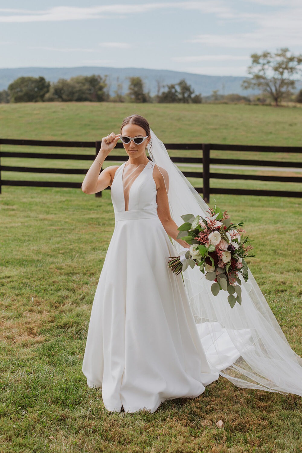 bride wears white sunglasses during wedding bridals