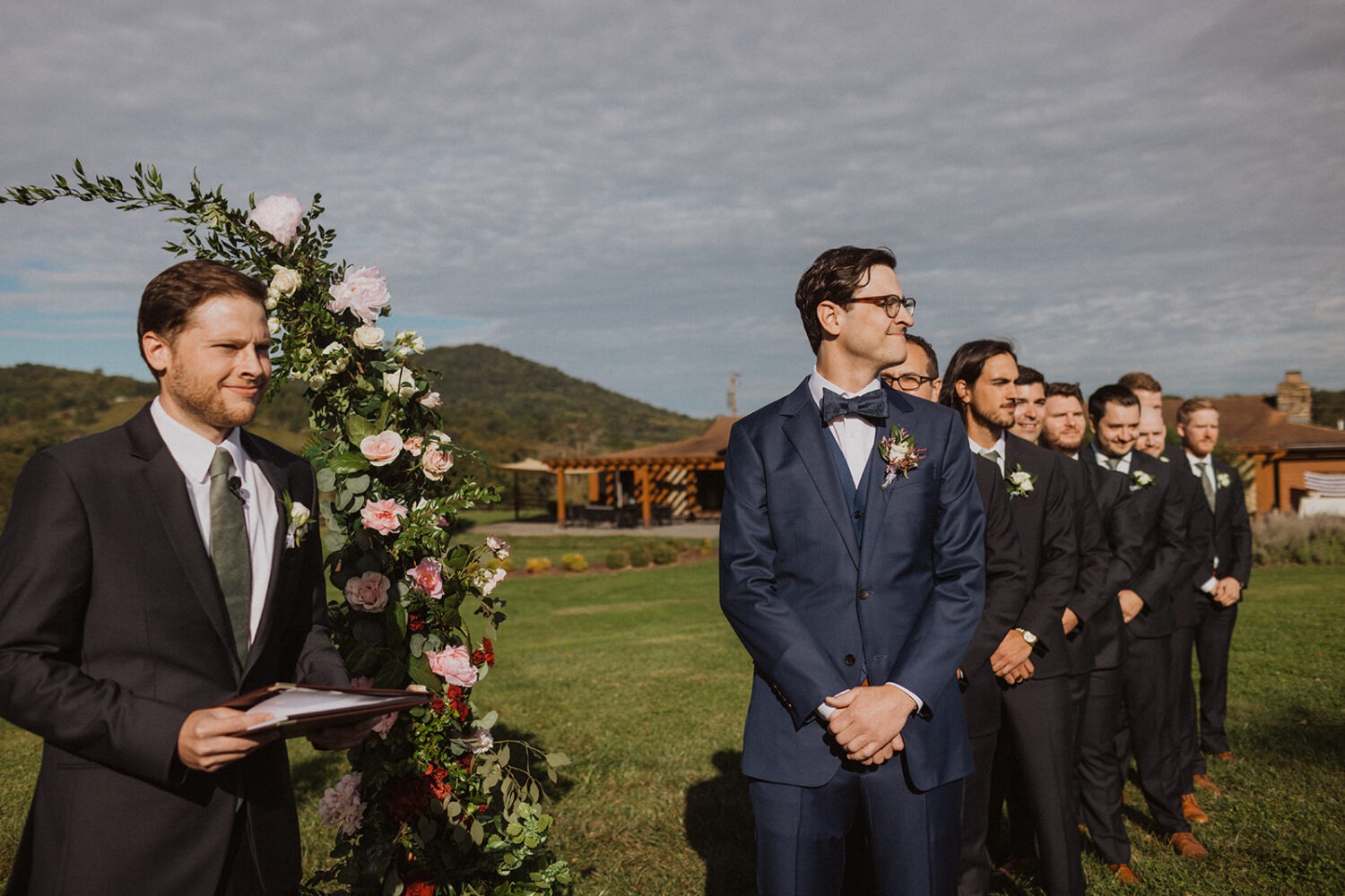 groom watches bride walk down aisle