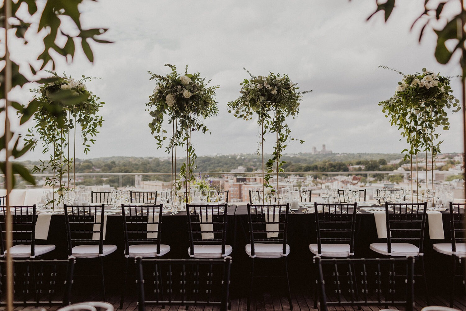 black and white wedding reception decor with greenery