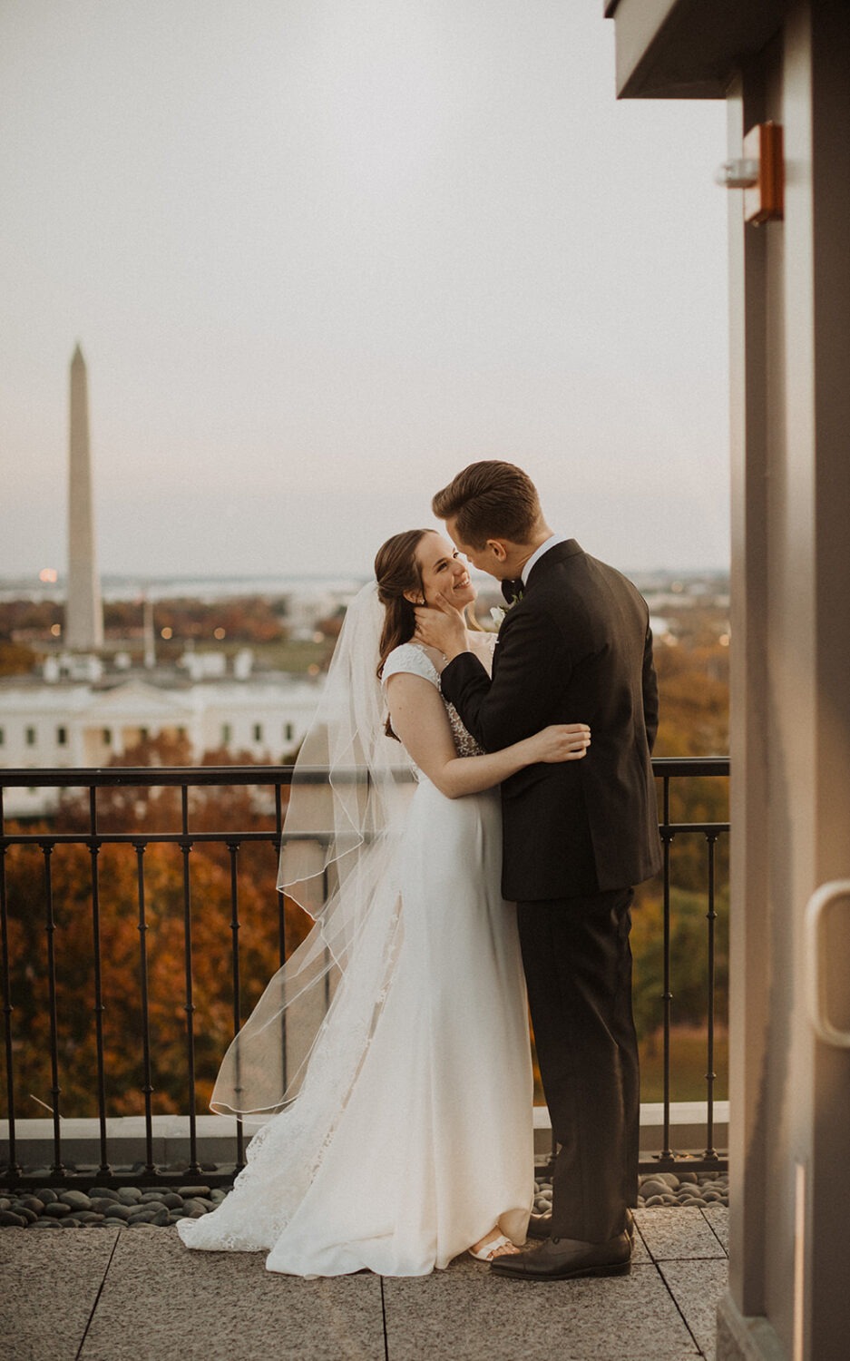 couple kisses on rooftop at The Hay-Adams hotel