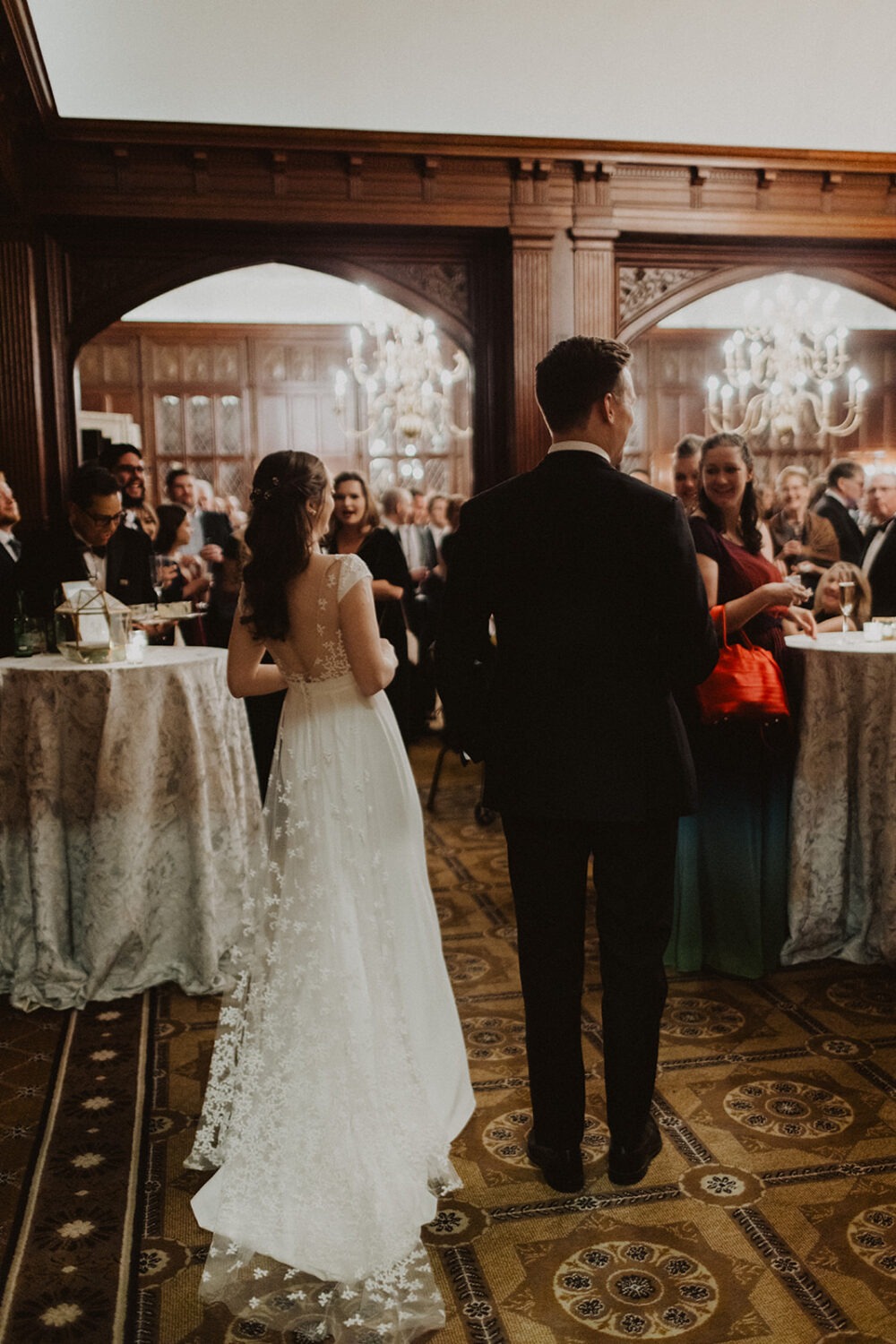 couple enter wedding reception at hotel