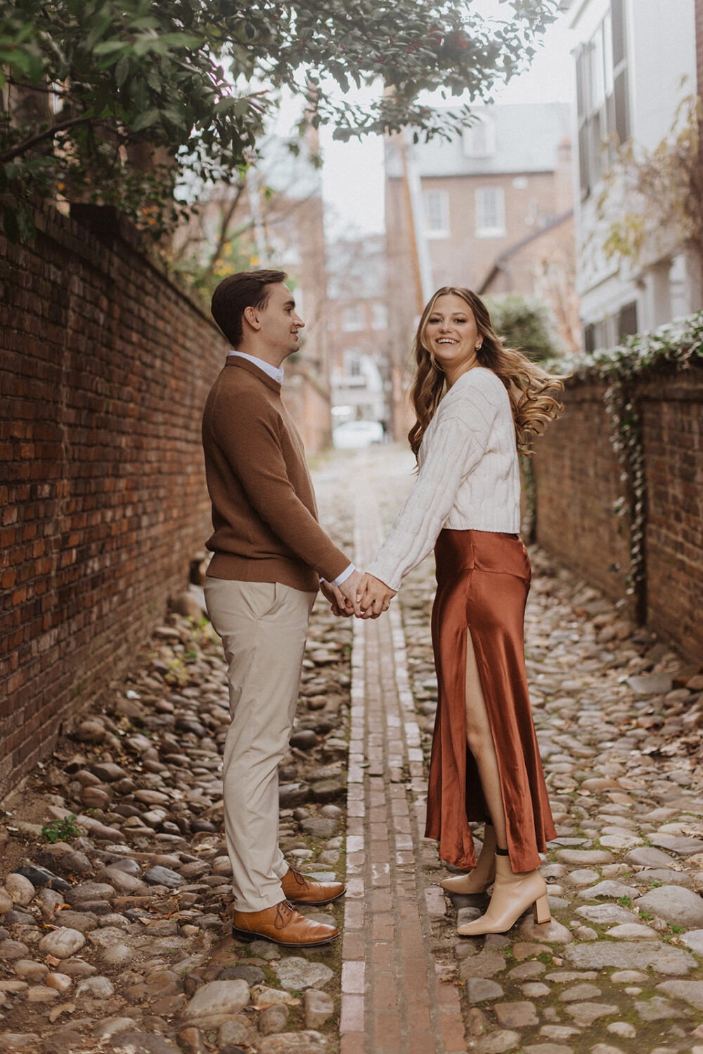 couple holds hands at Old Town Alexandria engagement session