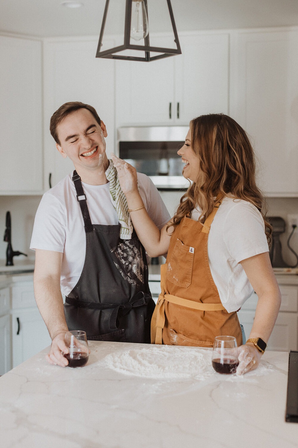 couple makes food in kitchen at home engagement session