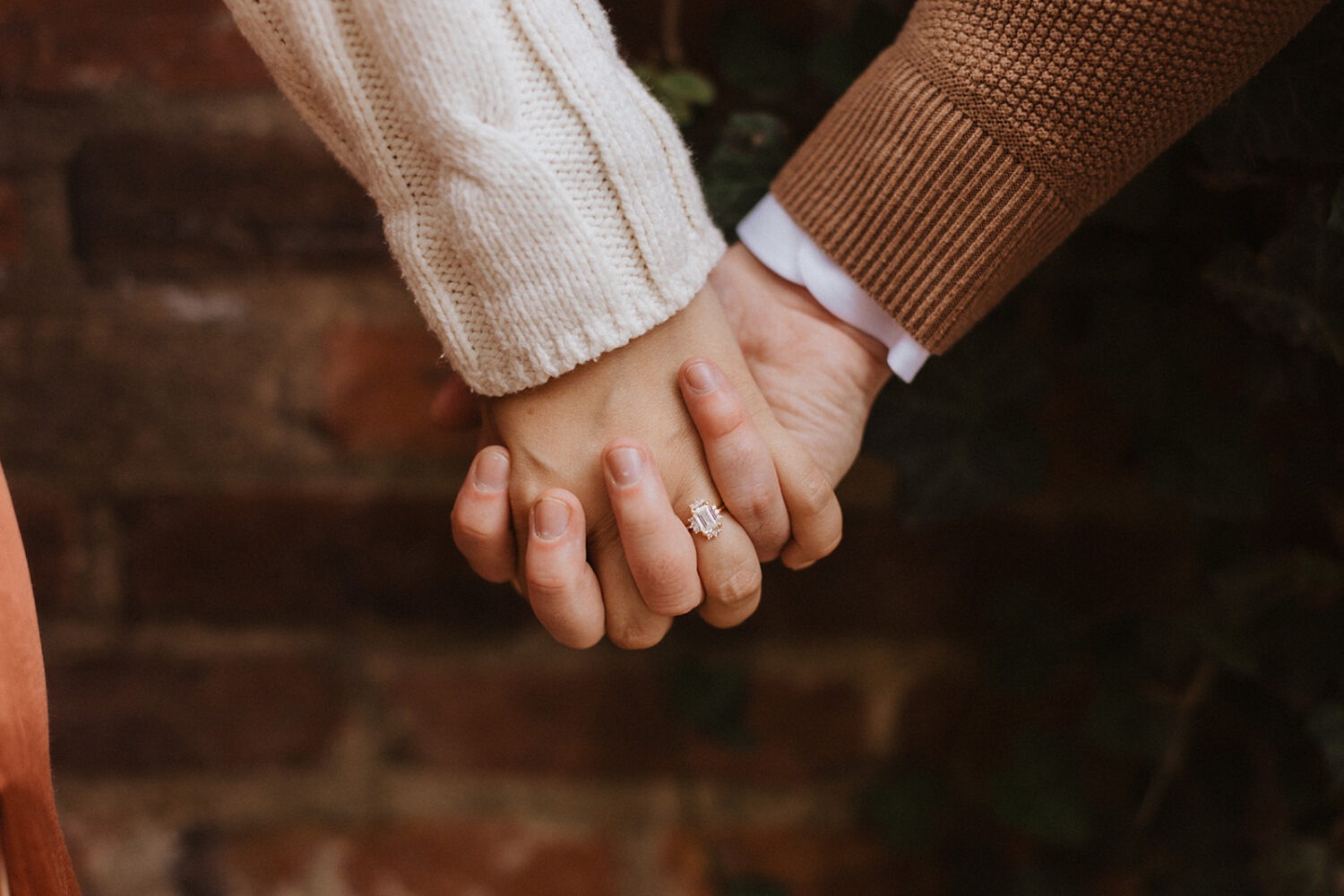 couple holds hands at winter engagement photoshoot