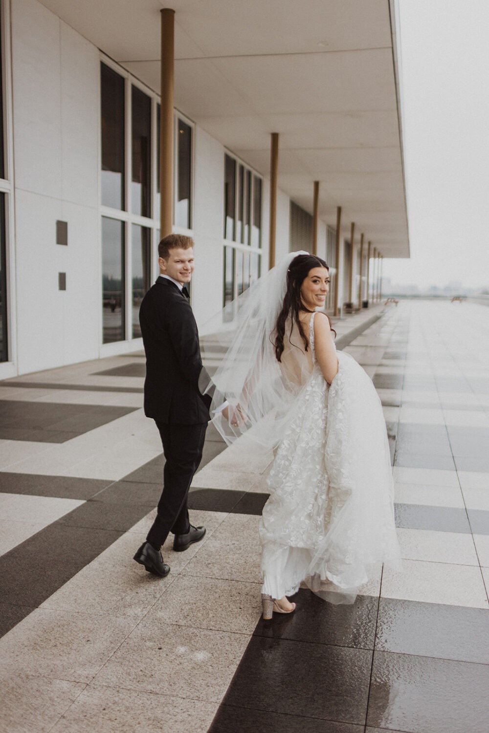 couple walks along rainy DC outdoor elopement