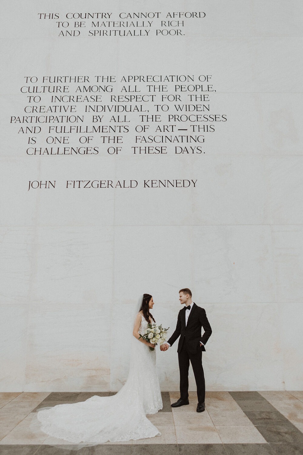 couple poses at Kennedy Center DC outdoor elopement