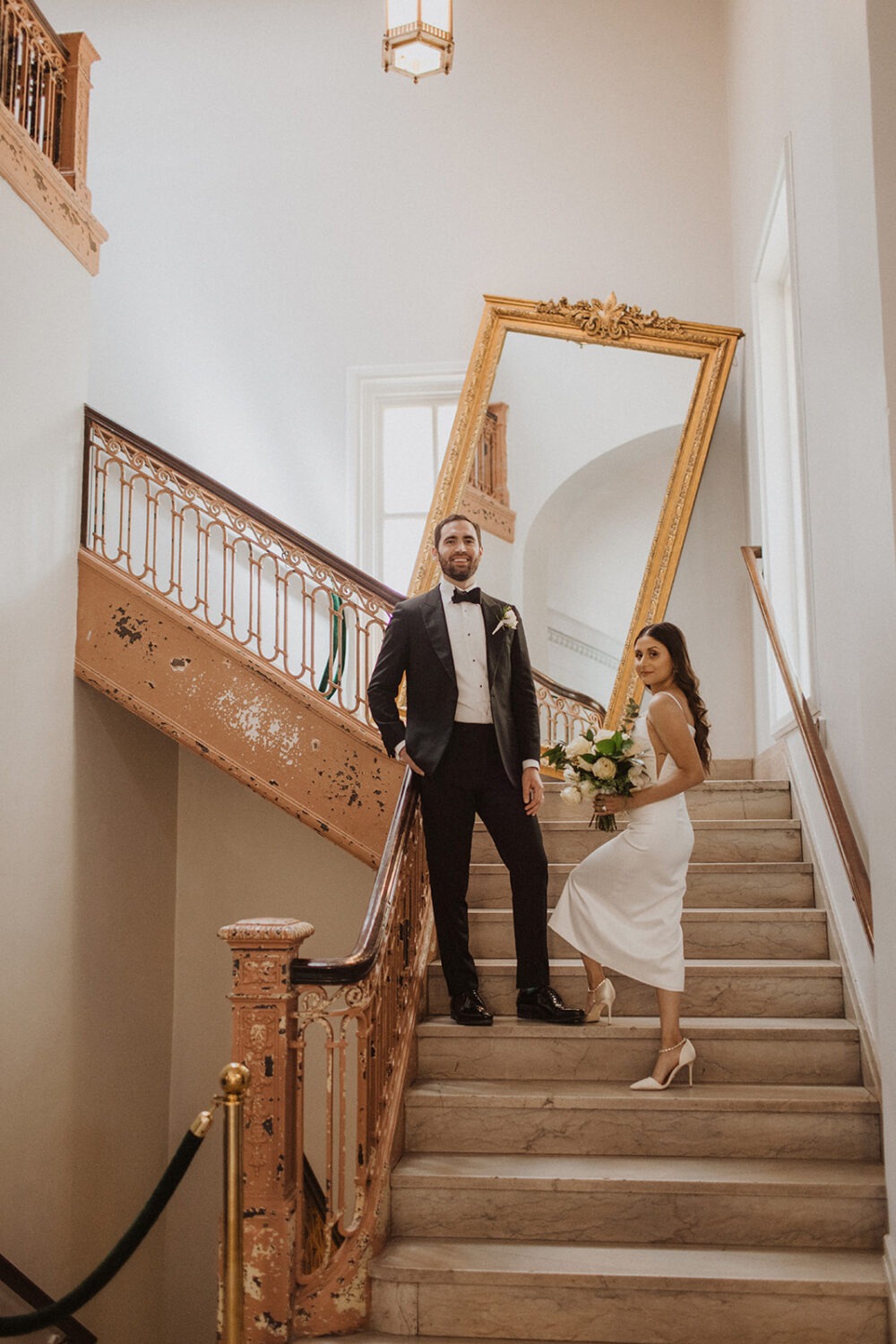 couple poses on stairs at The Line Hotel 