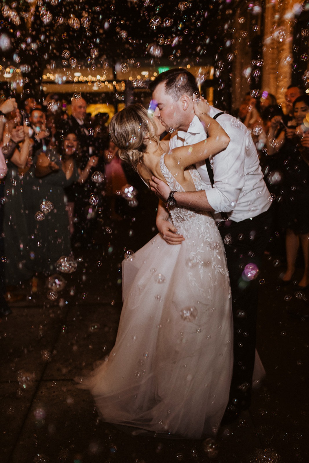 couple kisses during bubble wedding exit