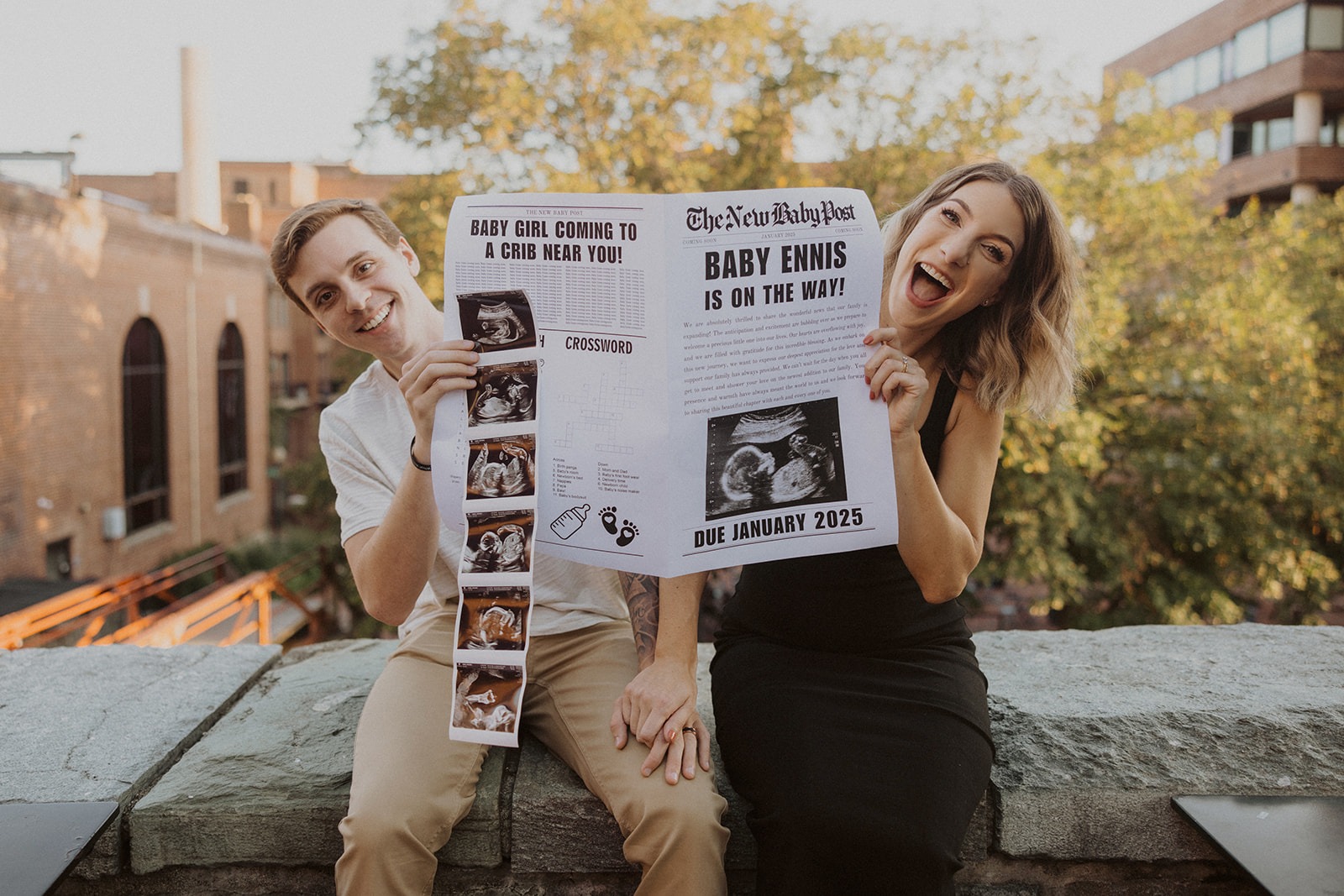 couple holds baby announcement newspaper and sonogram