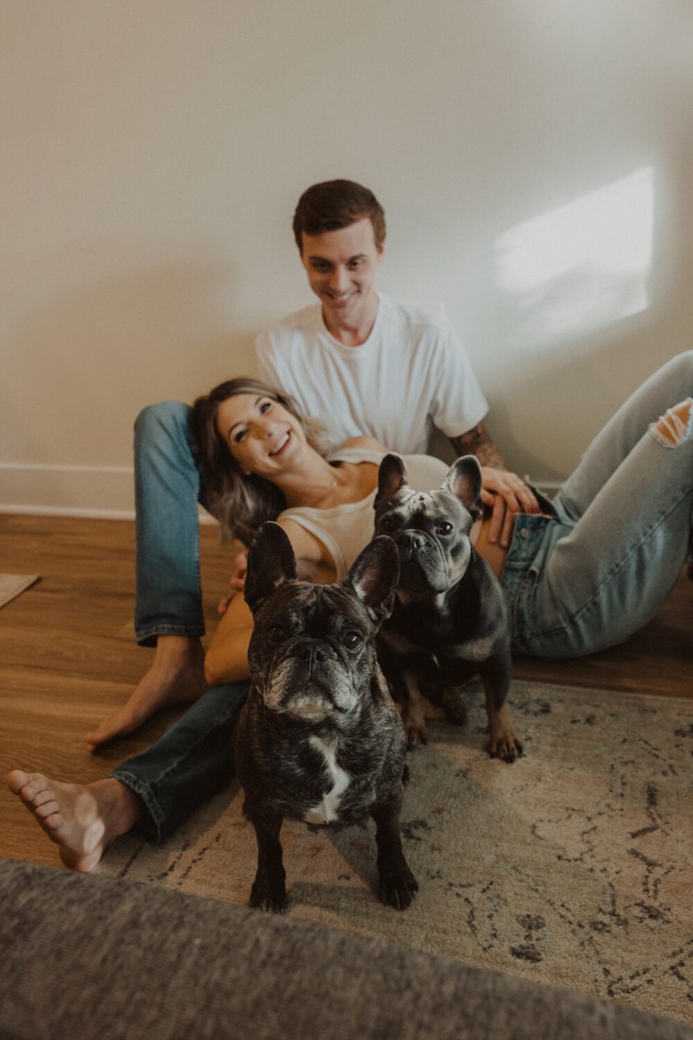 Couple poses for at-home maternity session with their dogs