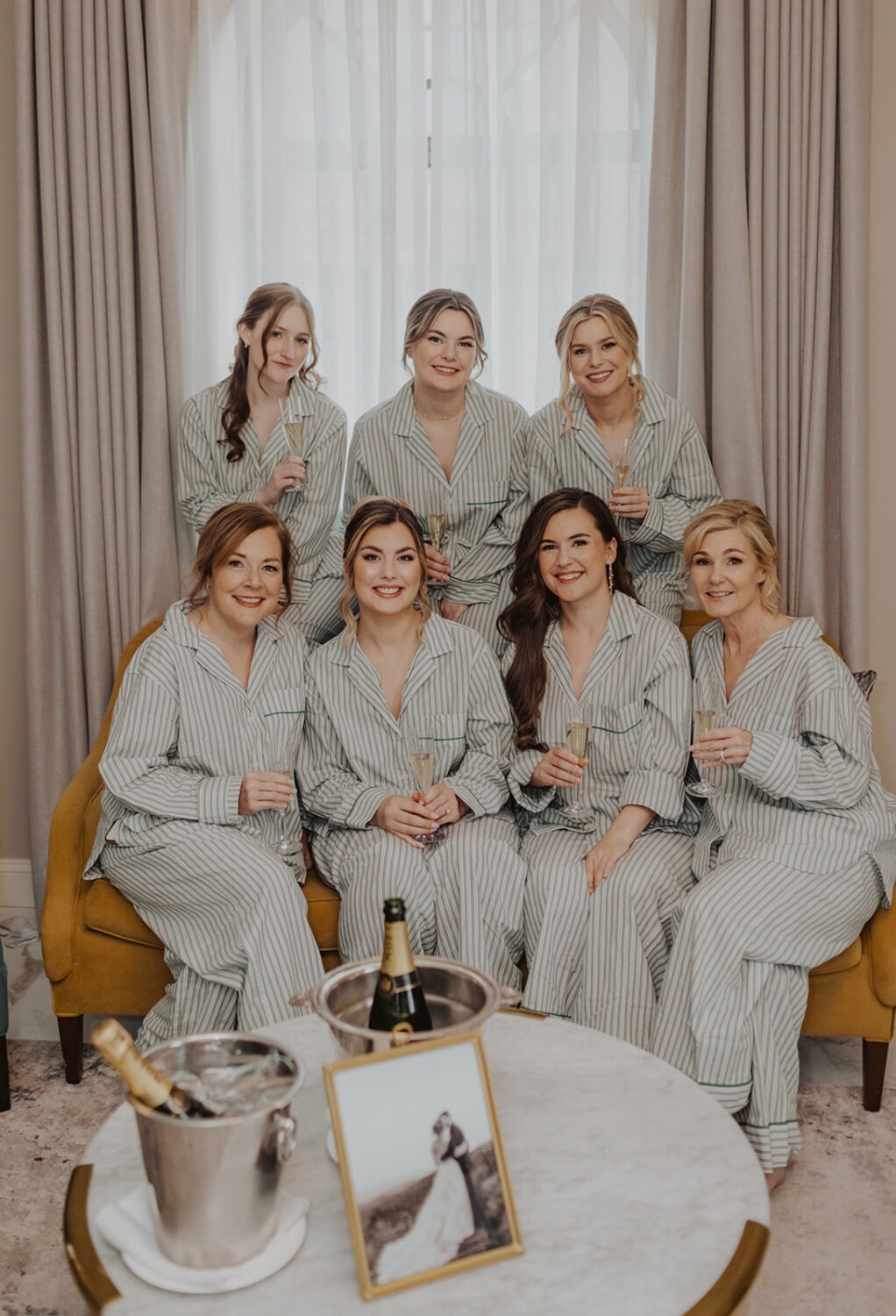 bride poses with bridesmaids in matching pajamas