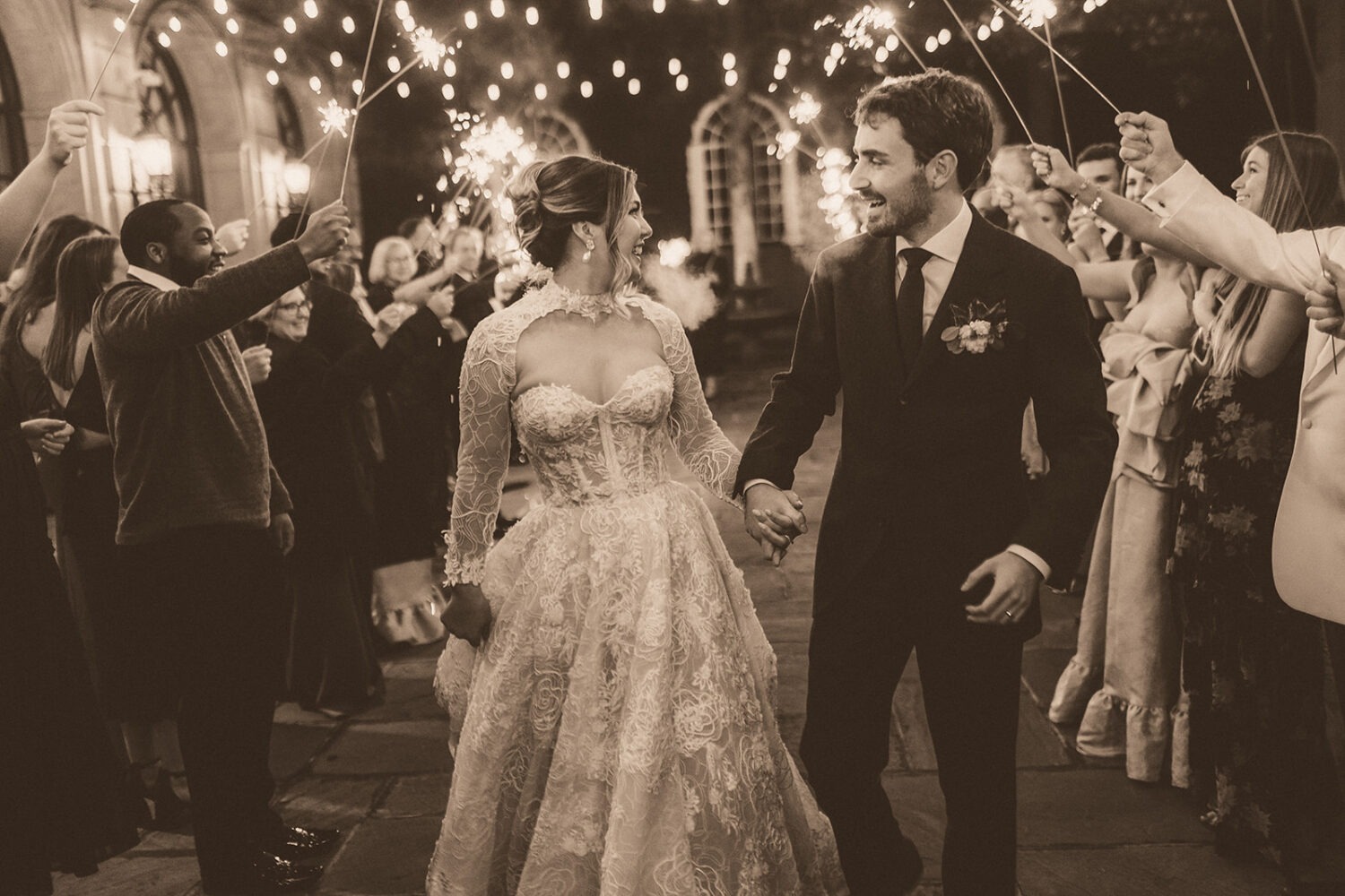 couple walks under sparkler wedding exit