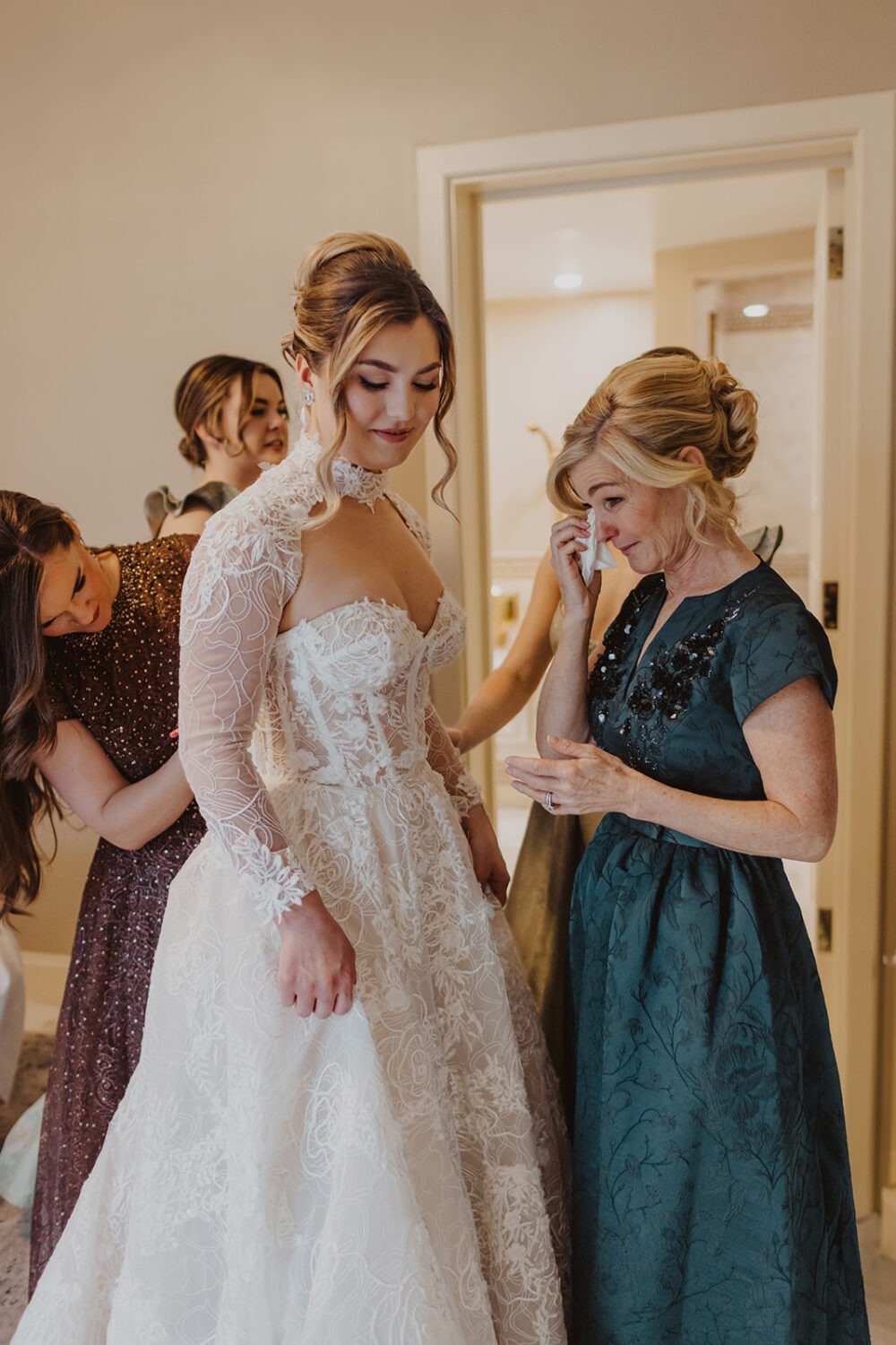 bridesmaids zip up bride's wedding dress