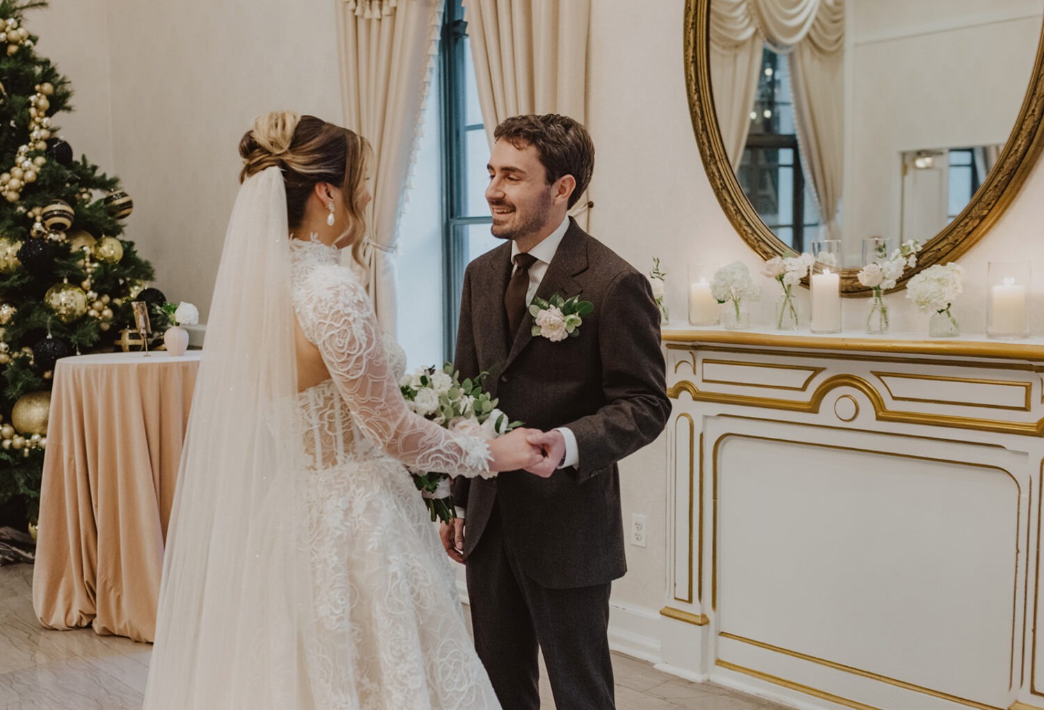couple holds hands during wedding first look
