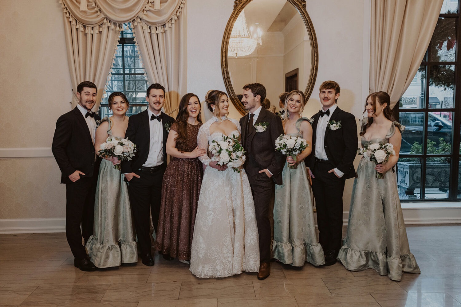 couple poses with wedding party