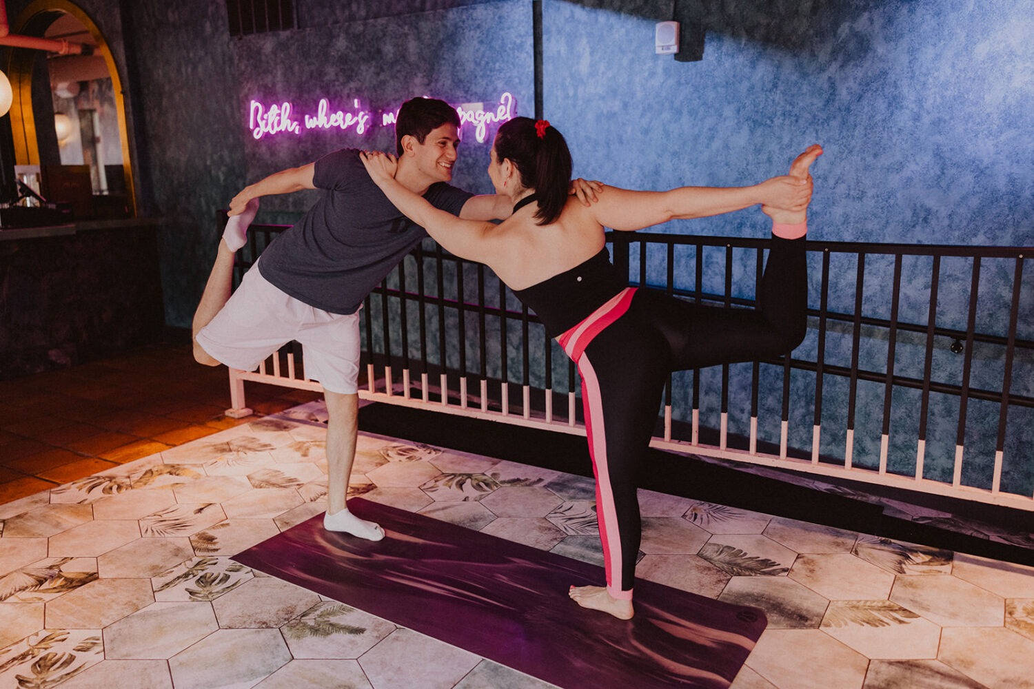 couple doing yoga poses during engagement shoot 