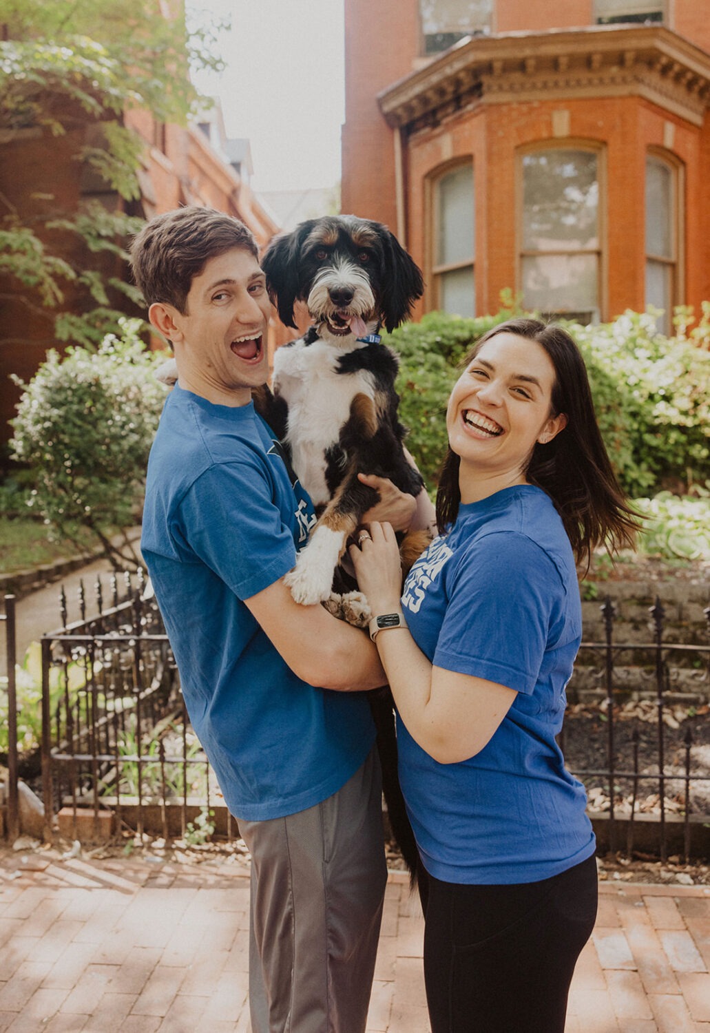 couple poses with dog during engagement shoot
