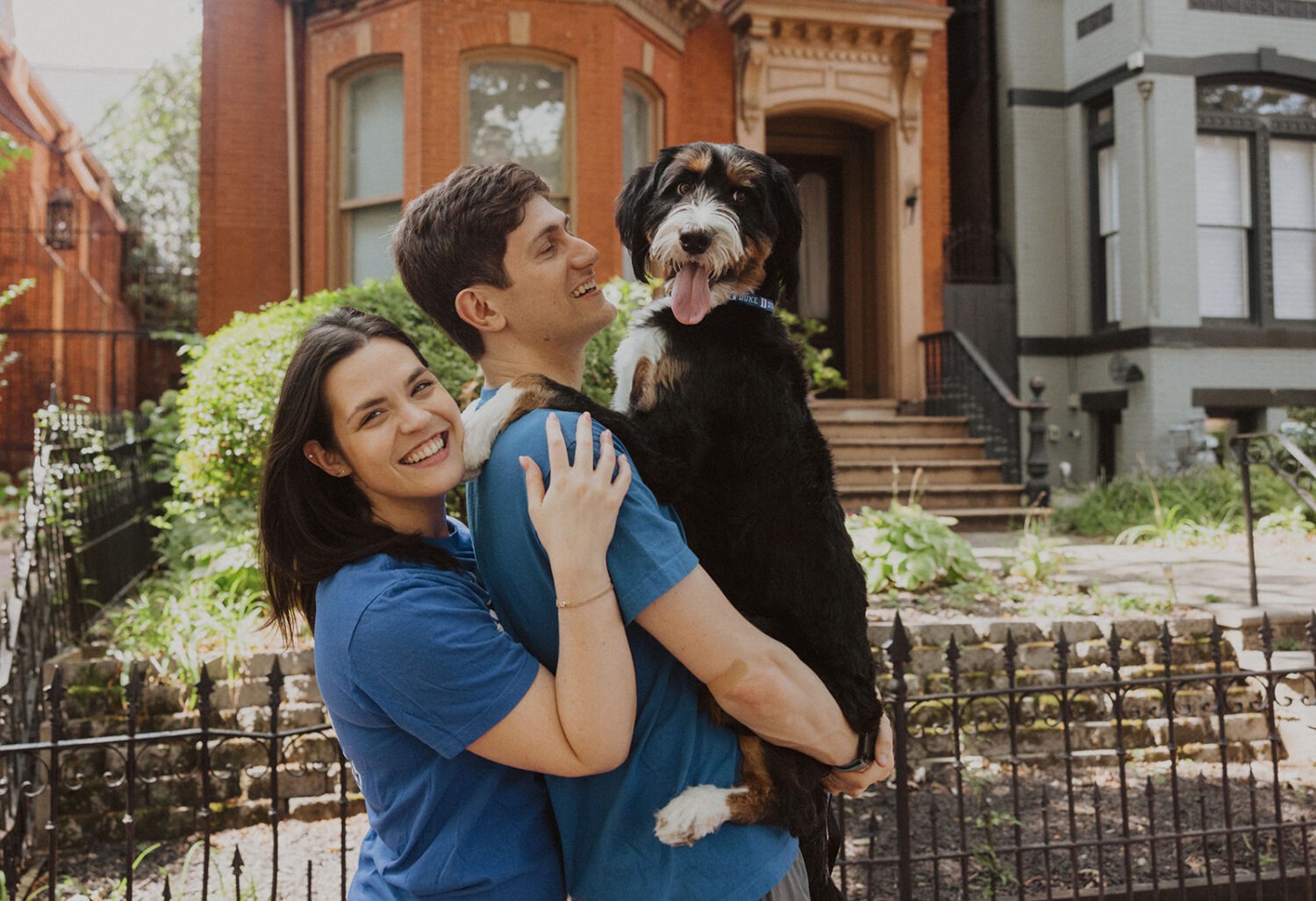 couple poses with dog during engagement shoot