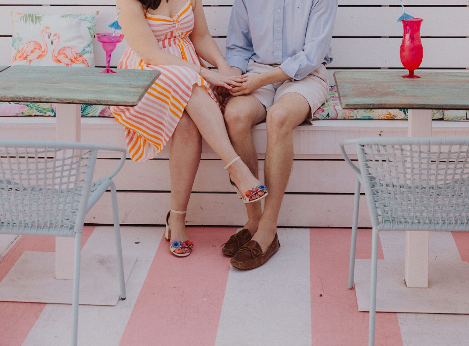 couple sitting holding hands during engagement shoot