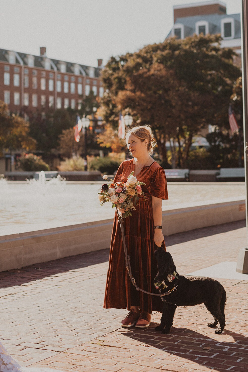 bridesmaid standing with dog during ceremony
