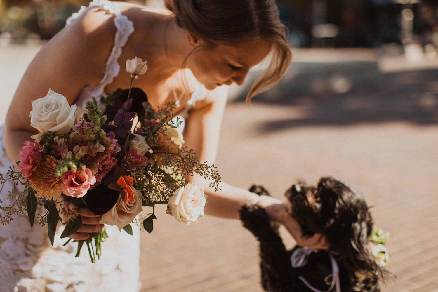 bride petting dog after ceremony