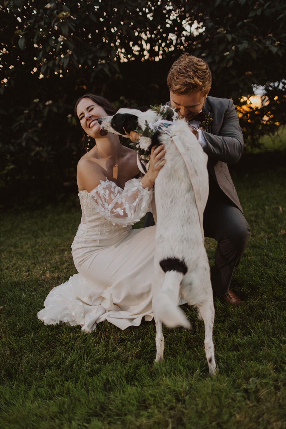 couple posing with their dog after wedding ceremony