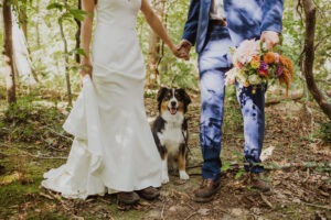 couple poses with their dog
