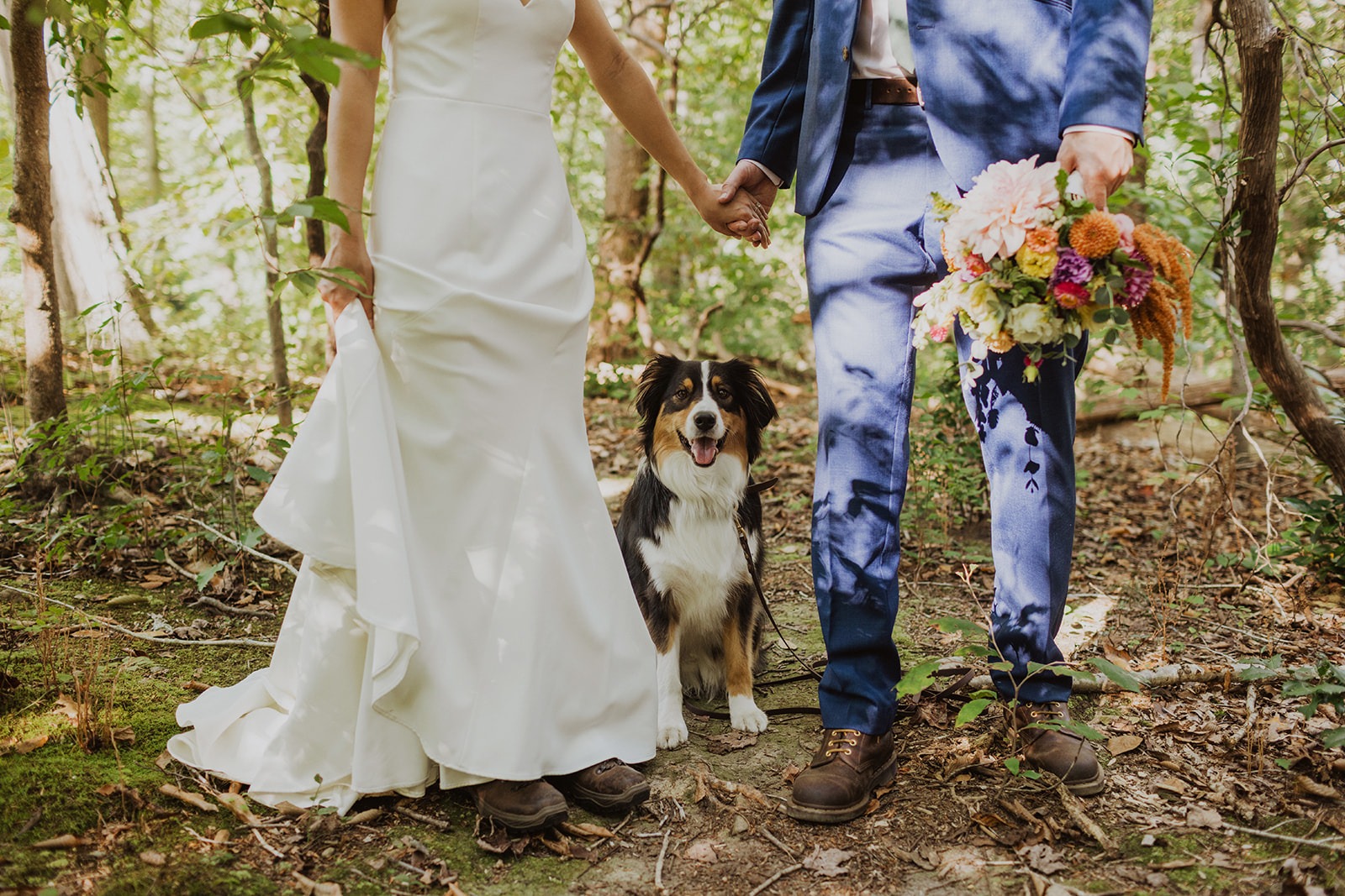 couple poses with their dog