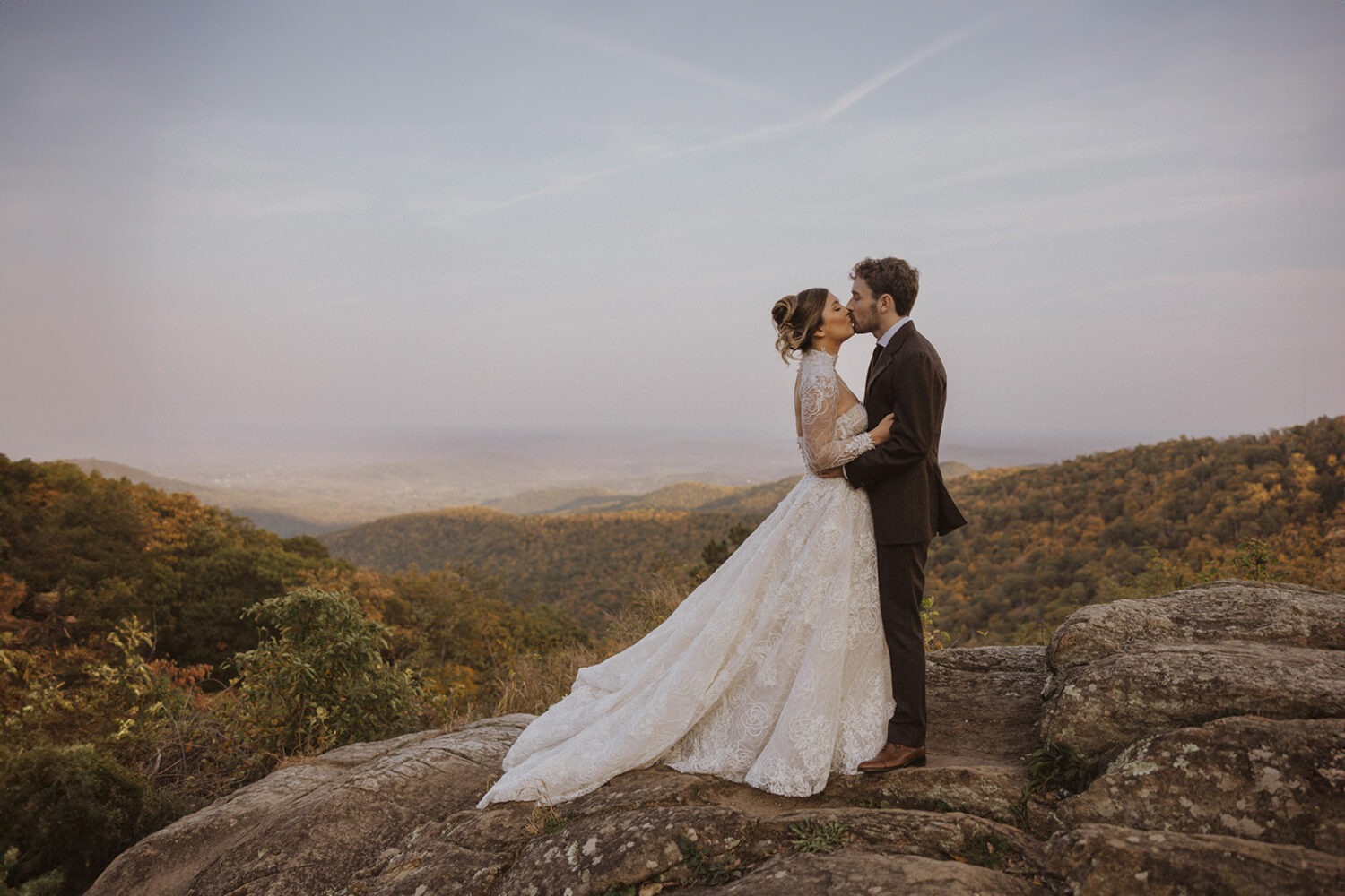 couple kisses on rocky landscape in Shenandoah National Park