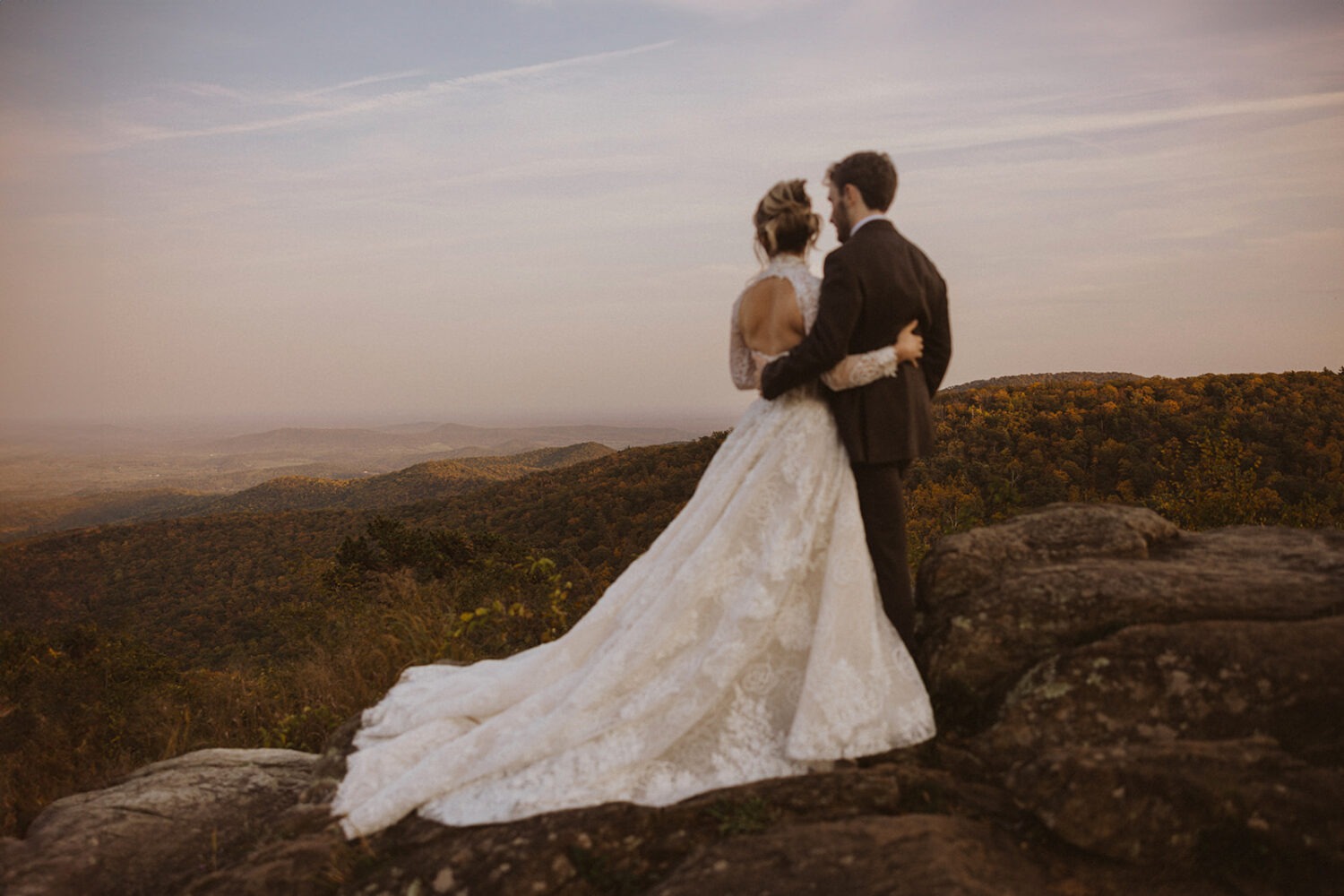 couple embraces on rocky landscape in Shenandoah National Park