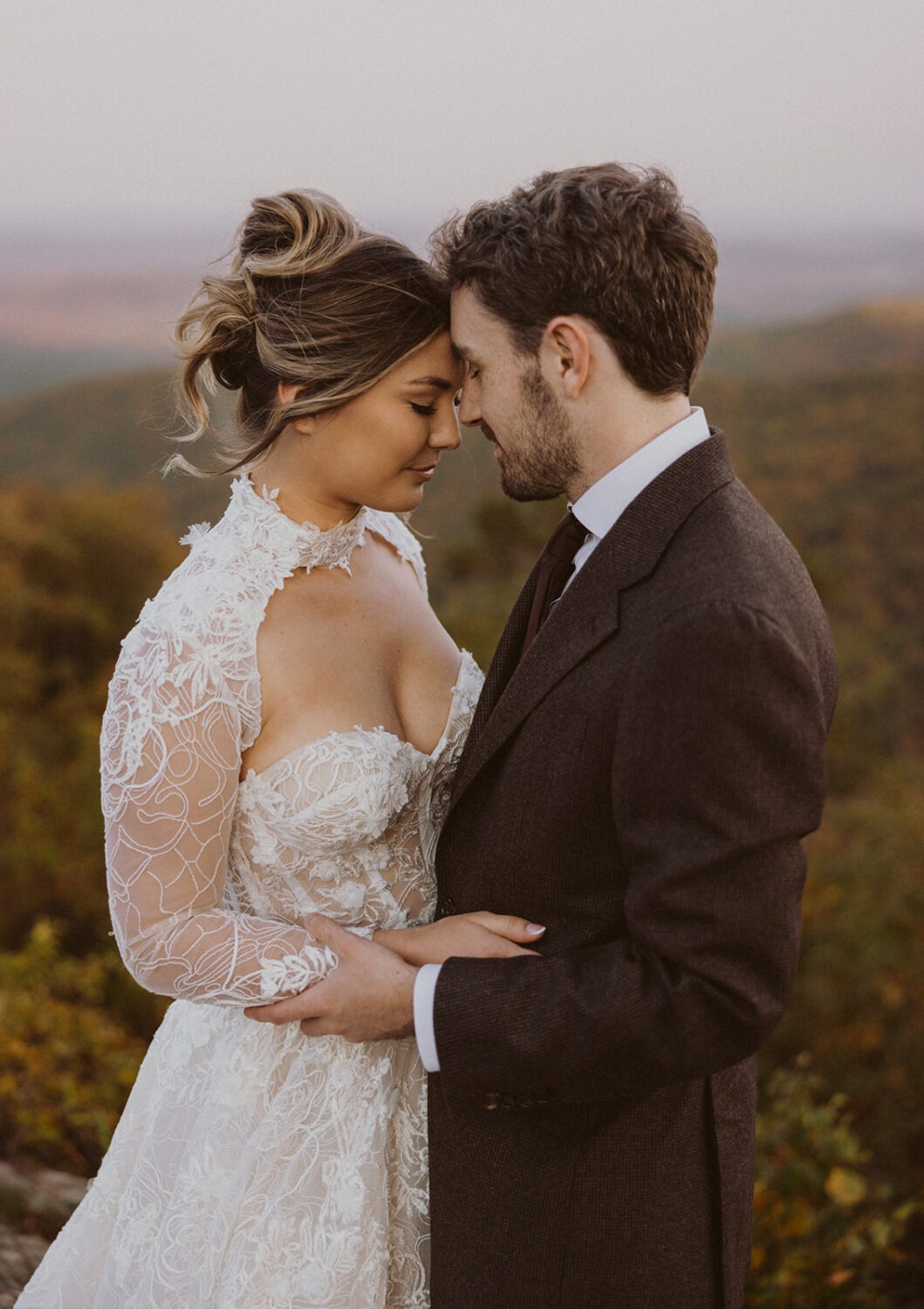 couple embrace in front of mountains for pre-wedding photos