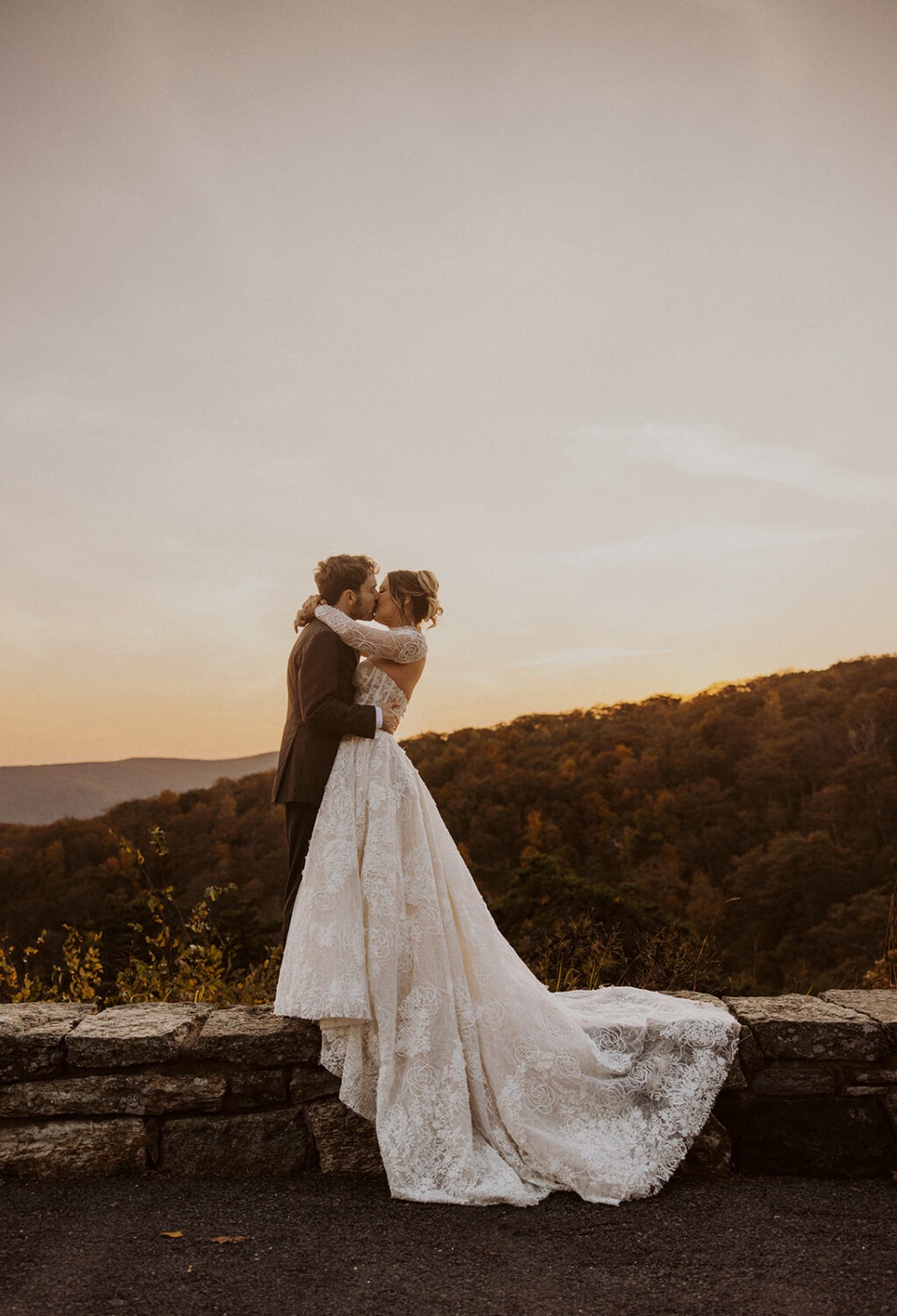 couple kisses on ledge at Shenandoah's skyline drive