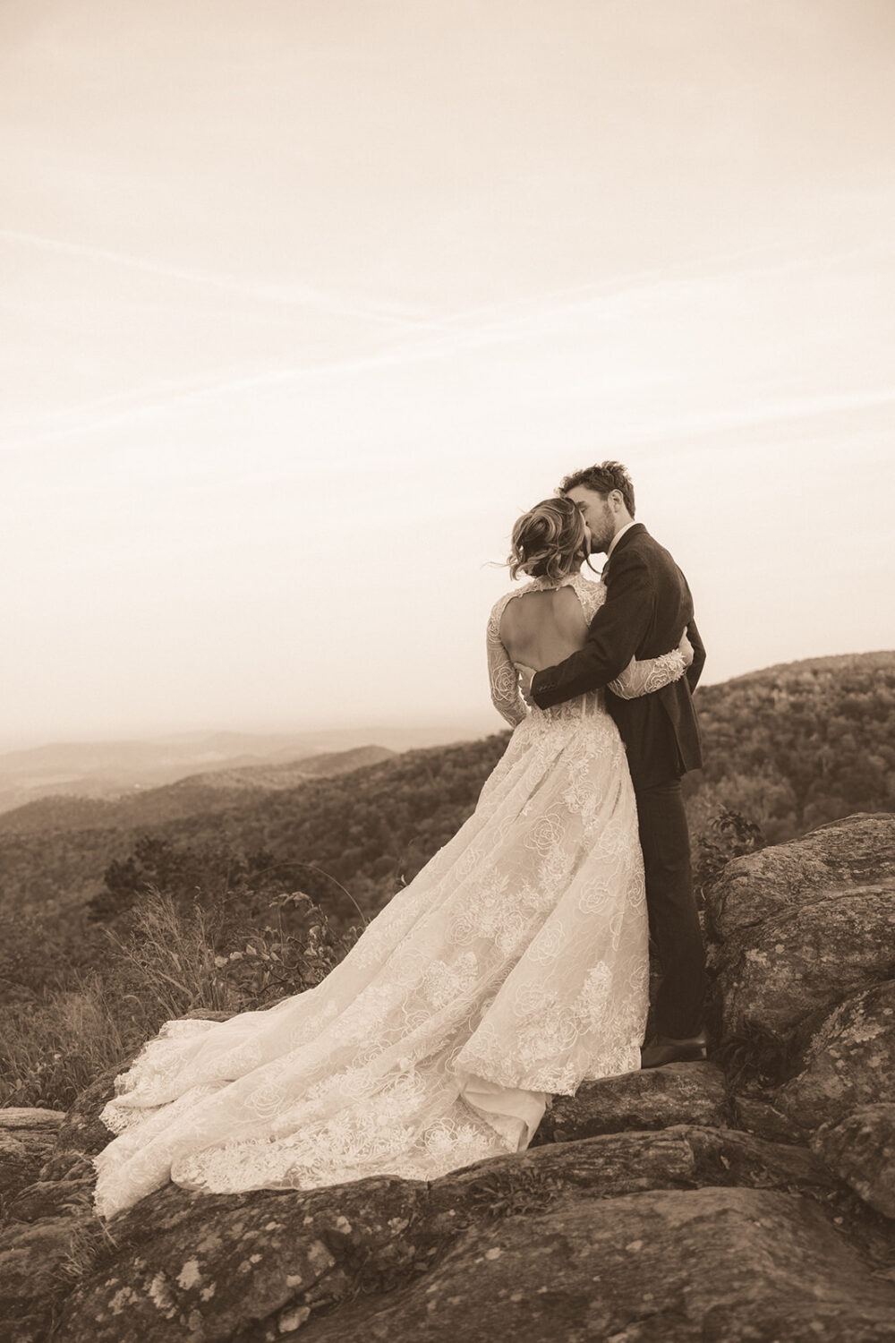 couple kisses on rocky landscape in Shenandoah National Park